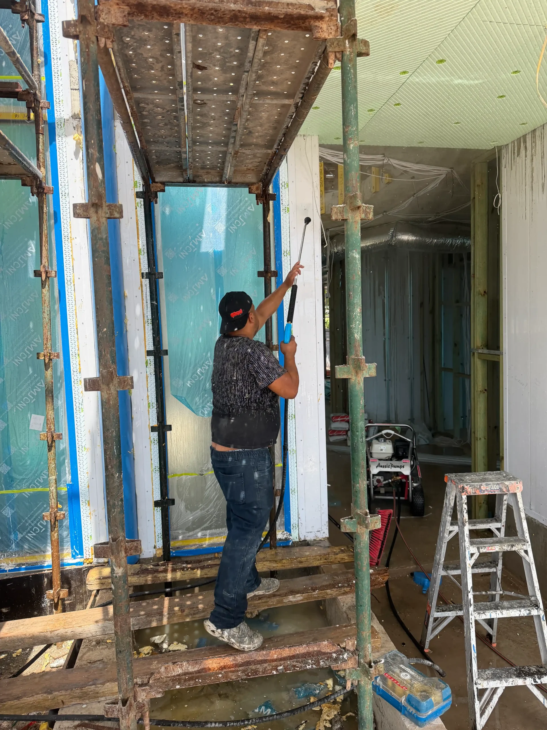 Sydney rendering contractors working on scaffold for wall finish