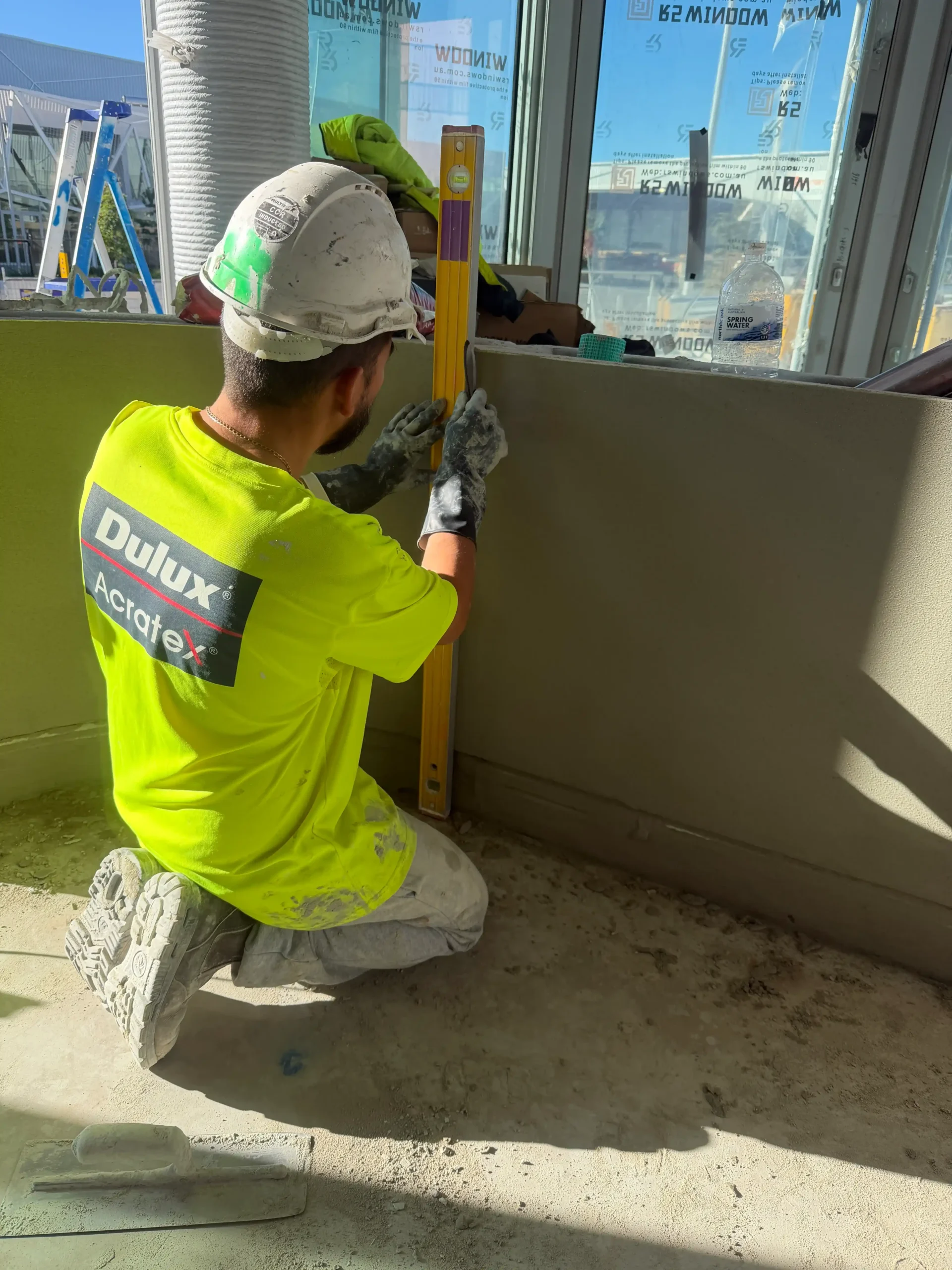 Sydney rendering contractor applying finish to wall surface